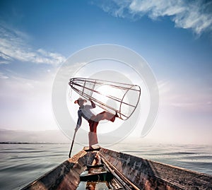 Burma Myanmar Inle lake fisherman on boat catching fish photo