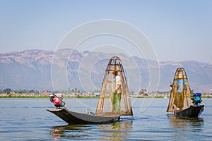 Burmese fisherman catching fish in Inle lake, Myanmar Burma by