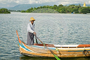 Burmese fishermen in small fishing boats near U-Bein Bridge, in Taungthaman Lake, Amarapura, Myanmar