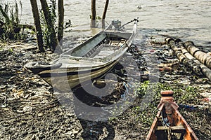 Burmese homemade motor boat left by tide on riverbank 3