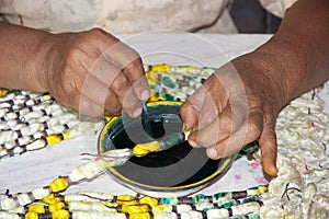 Burmese woman is colouring the lotus thread