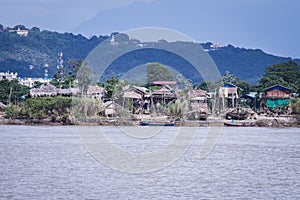 Burmese wooden houses beside the Irrawaddy River