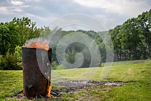 Burn barrel in a rural area used to incinerate trash and garbage. photo