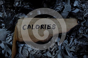 Burn calories concept. Burning paper with written word calorie.