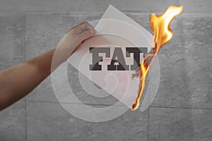 Burn fat text on burning paper