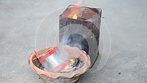 Burn joss paper gold and silver paper as sacrificial offering for pray to god