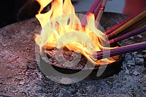 Burn joss sticks on fire