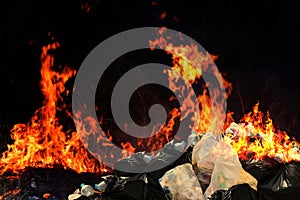Burn a lot of waste plastic garbage, Garbage bin pile Dump Lots of junk Polluting with Plastic Burning heap of smoke photo