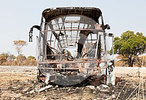 Burned bus at the side of the road