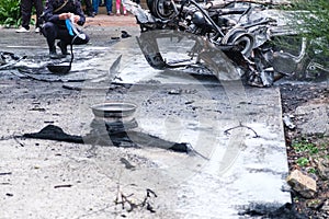 Burned car after an accident on the road. Police at the scene of the accident.