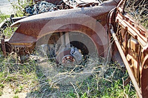 Burned car with bare body and rusting