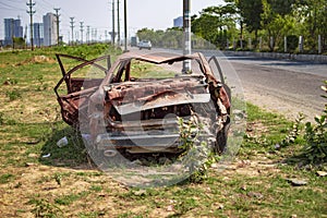 Burned car with burnt paint on the road side