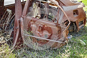 Burned car with burnt and rusty body