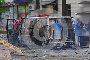 Burned car in the center of city after unrest