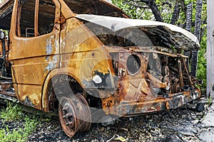 Burned car. Consequences of car accident. Damaged by arson. Machine after a fire