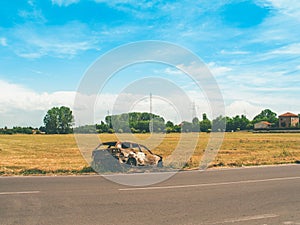 Burned car in a field