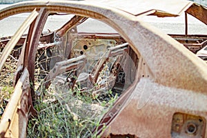 Burned car with no parts remaining as those were burnt