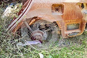 Burned car with red rust on its body