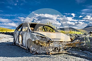 Burned car on the road