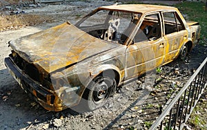 burned car sedan after street riots