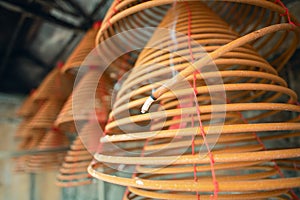 Burned coil swirl incense in Macau Macao temple, traditional Chinese cultural customs to worship god, close up, lifestyle.