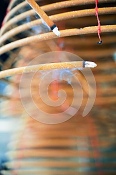 Burned coil swirl incense in Macau Macao temple, traditional Chinese cultural customs to worship god, close up, lifestyle.