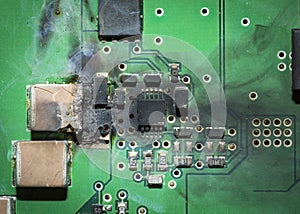 Burned electronic SMD printed circuit board PCB after a short circuit