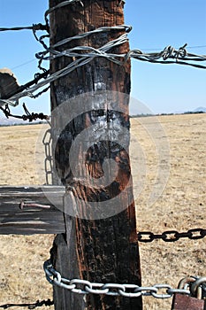 Burned Fence Post Wire and Chain