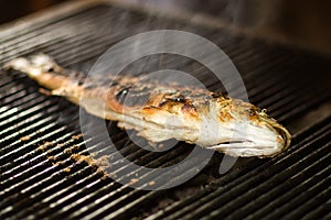Burned fish on grill photo