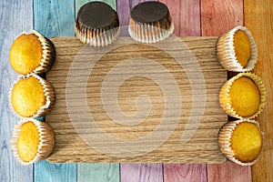 Burned homemade cornbread muffins on a pastel wood background, room for copy. Concept for baking mishaps, mistakes photo