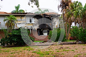 Burned house with major fire damage to siding, windows and roof