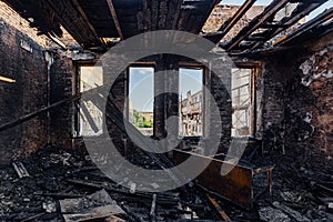 Burned interiors after fire in industrial or office building. Burnt furniture