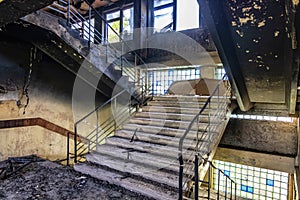 Burned interiors after fire in industrial or office building. Walls and staircase in black soot