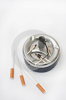 Burned matches in the ashtray and filter cigarettes
