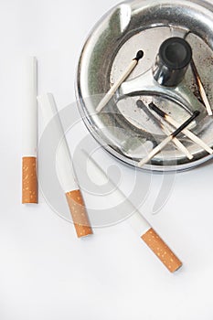 Burned matches in the ashtray and filter cigarettes