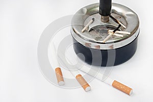 Burned matches in the ashtray and filter cigarettes