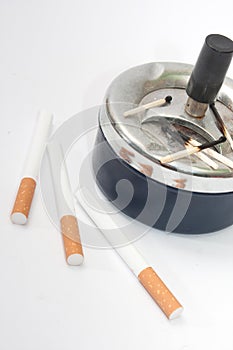 Burned matches in the ashtray and filter cigarettes