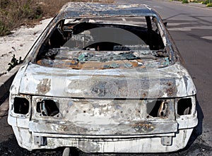 Burned out car in street