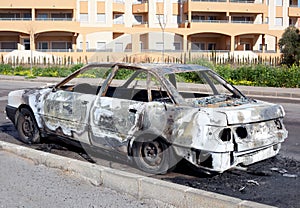 Burned out car in street