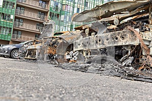 Burned out front of cars after a fire in one of the city`s districts