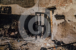 Burned room interior in apartment house. Burned door and charred walls