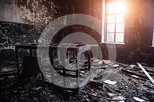 Burned room interior in apartment house. Burned furniture and charred walls in black soot