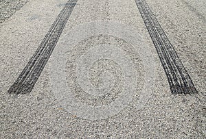 Burned rubber tire track on an asphalt road
