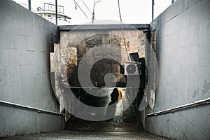 Burned underground pedestrian crossing after a fire or terrorist attack, walls in soot and smoke