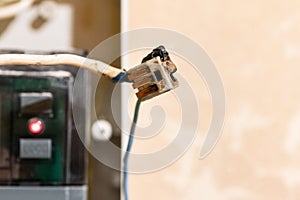 Burned wire, splicing connector, electrical terminal block of nonflammable, fireproof material. Faulty wiring or negligent