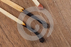 Burned wooden matches sticks on a wooden table background