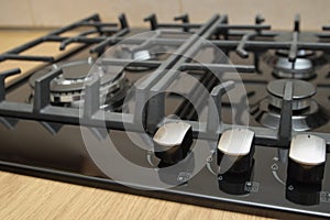 Burners on a black gas cooker in the kitchen