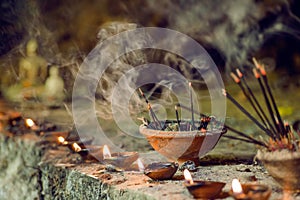 Burning aromatic incense sticks inside temple. Incense for praying Buddha or Hindu gods to show respect