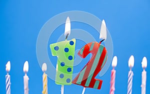 Burning birthday cake candle number 12. Happy Birthday background anniversary celebration concept