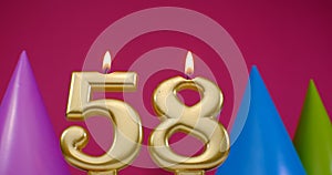 Burning birthday cake candle number 58. Happy Birthday background anniversary celebration concept. Birthday hat in the